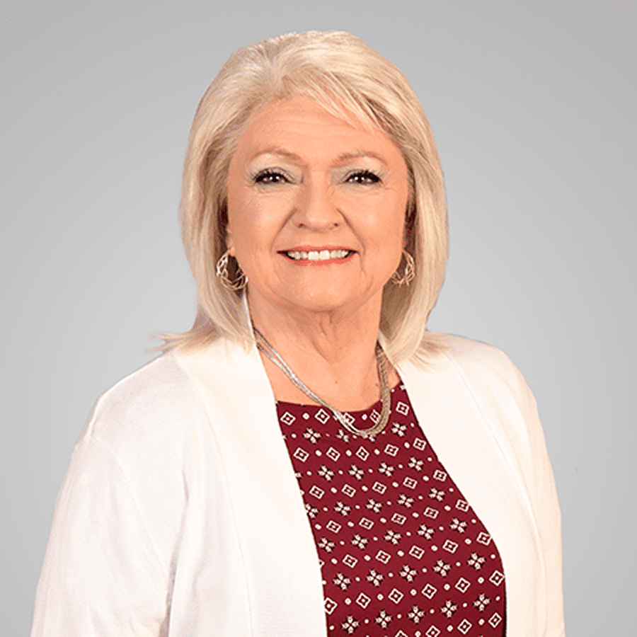Smiling older woman in white blazer