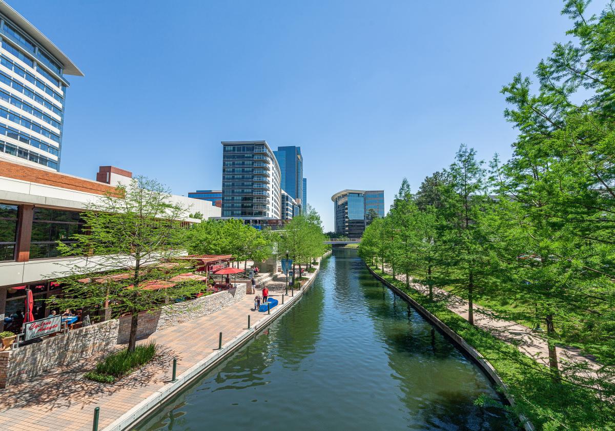 Urban canal with walkway and modern buildings