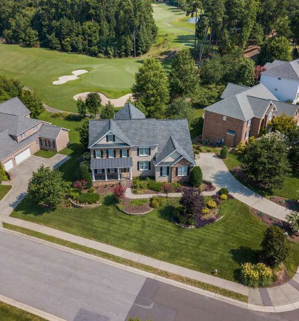 Aerial view of suburban house by golf course
