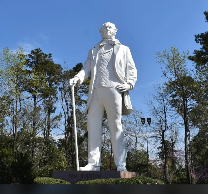 Large white statue of man holding cane