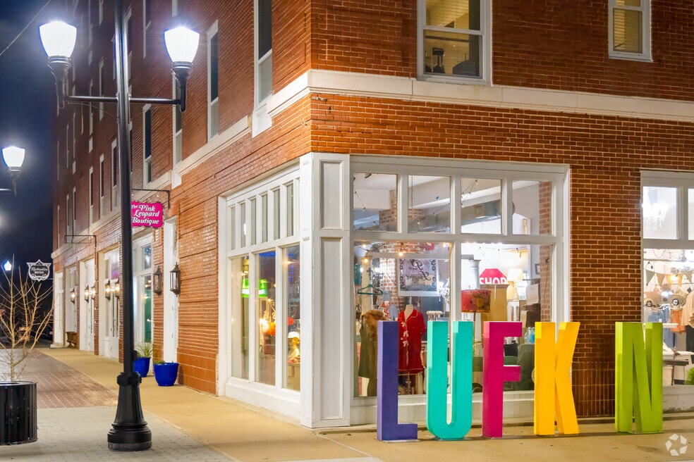 Corner brick storefront with colorful letters