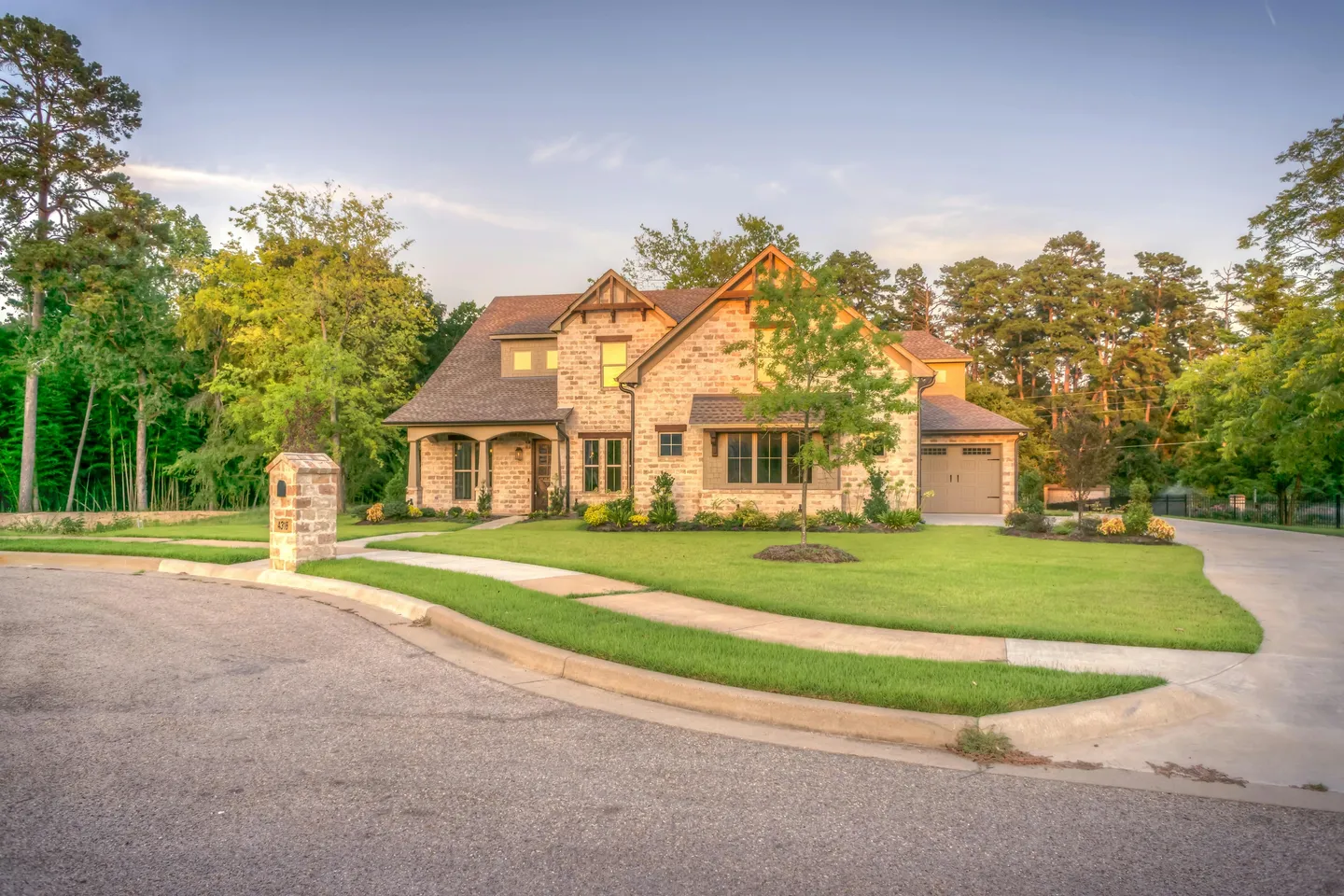 Two-story brick house with landscaped lawn