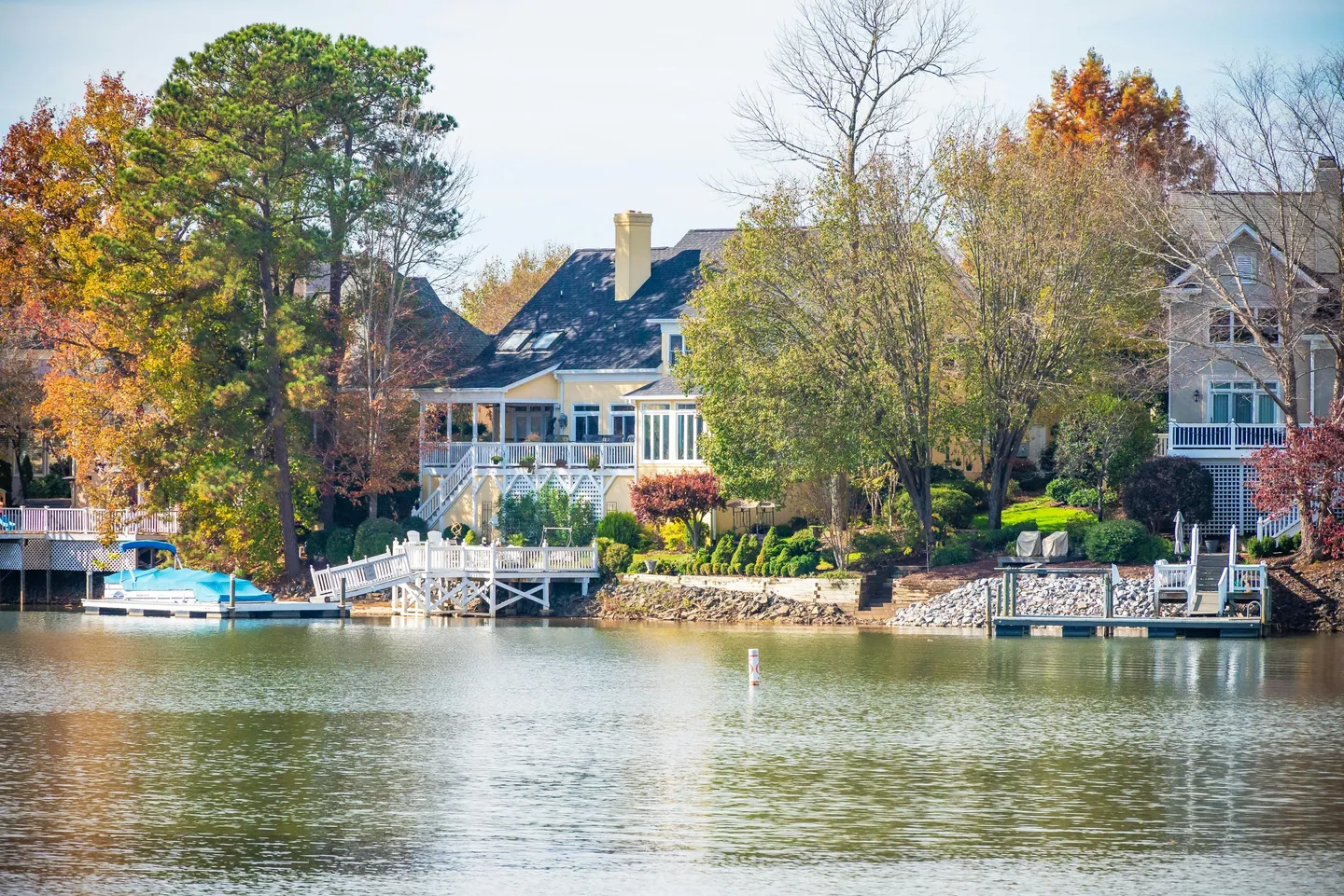 Lakeside houses with docks and autumn trees